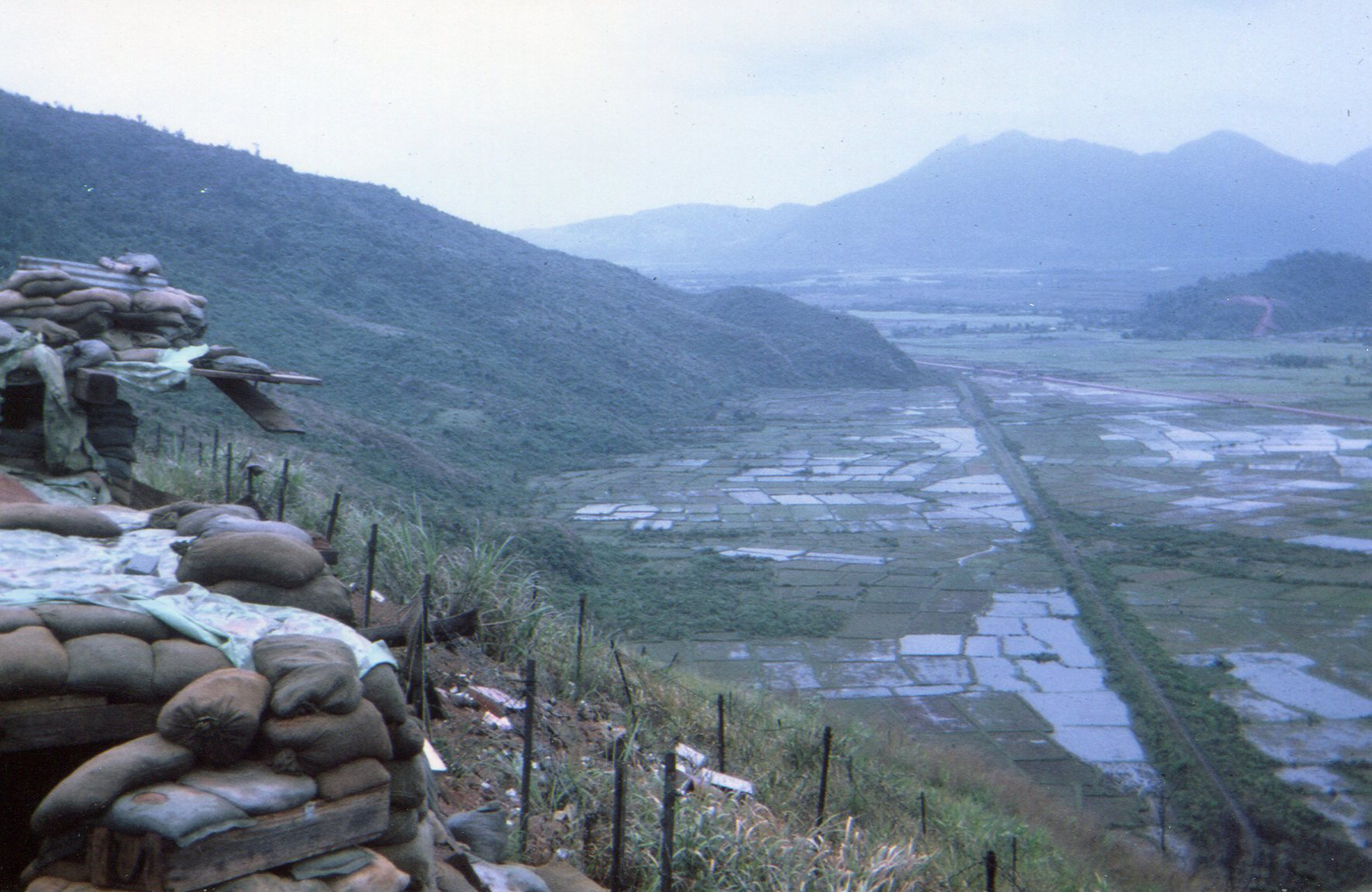View from top level of Hill 90 overlooking rice paddies, French railroad, and highway #1 – photo taken March 1968