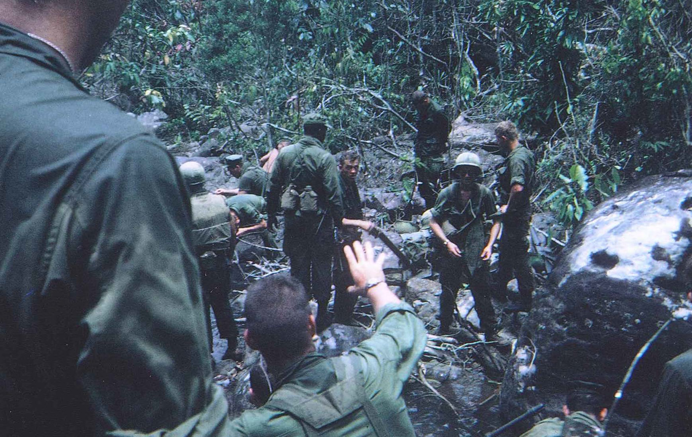 Patrol in mountain canopy near Hill 90 taking a water break – photo taken in February 1968