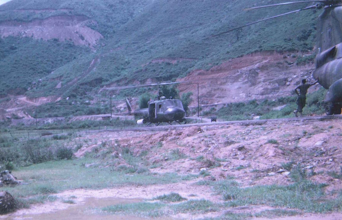 UH1 Huey chopper with rocket pod staged on LZ during Rough Rider duty – photo taken in December 1967